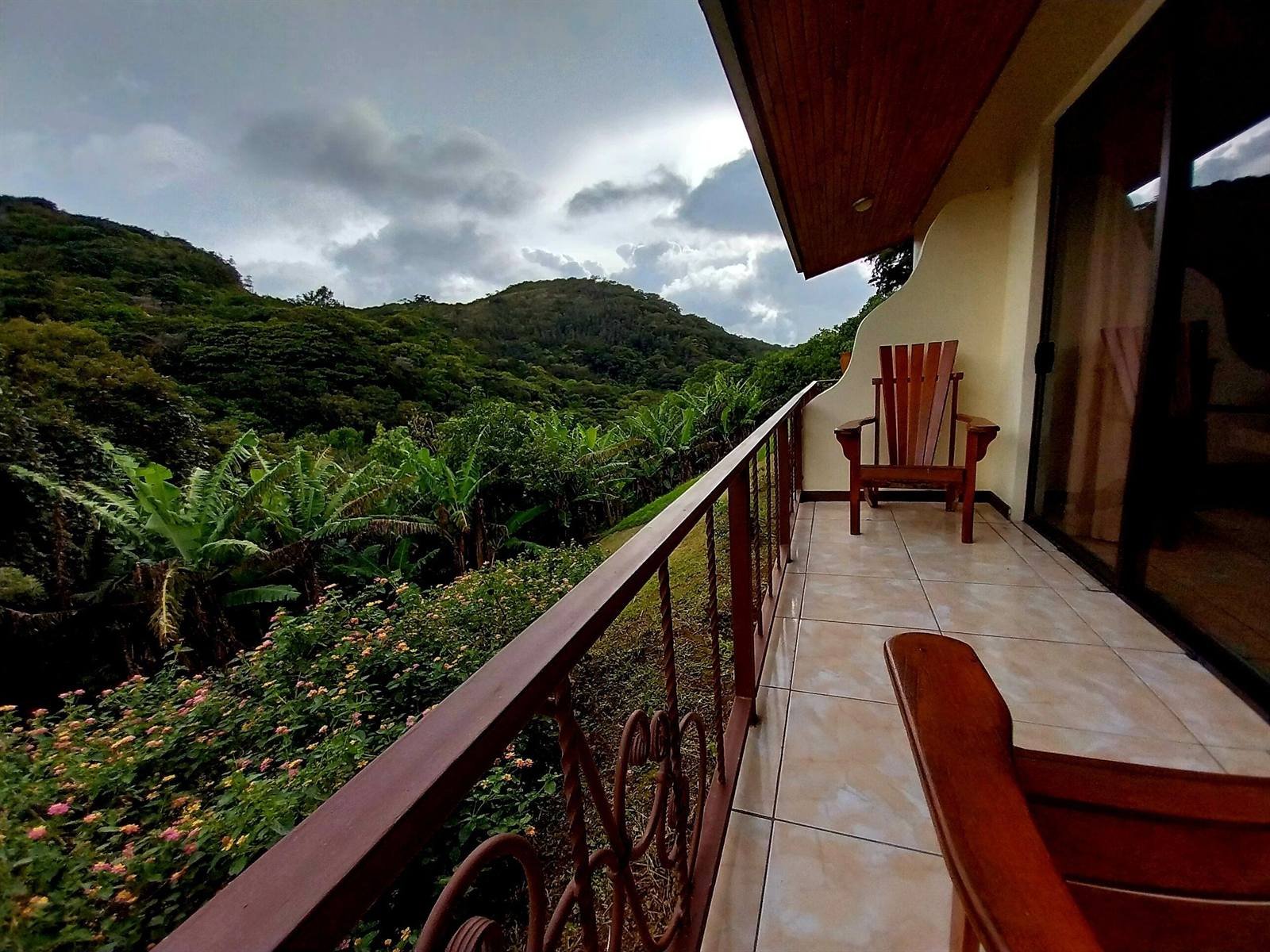 Balcony overlooking lush vegetation and hills